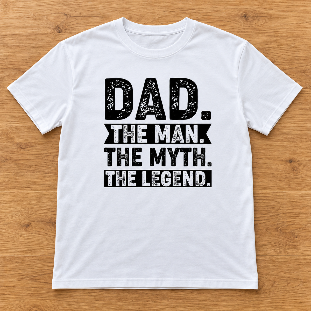 White Dad. The Man. The Myth. The Legend. Tee laid flat on light wood