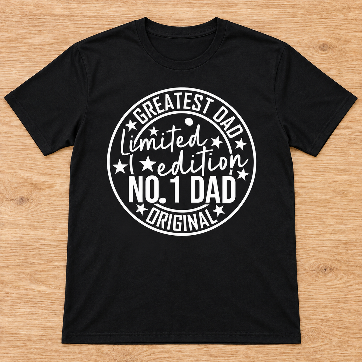 Black Limited Edition Greatest Dad Tee laid flat on light wood