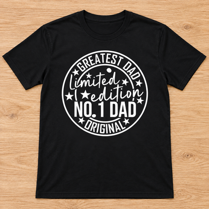 Black Limited Edition Greatest Dad Tee laid flat on light wood