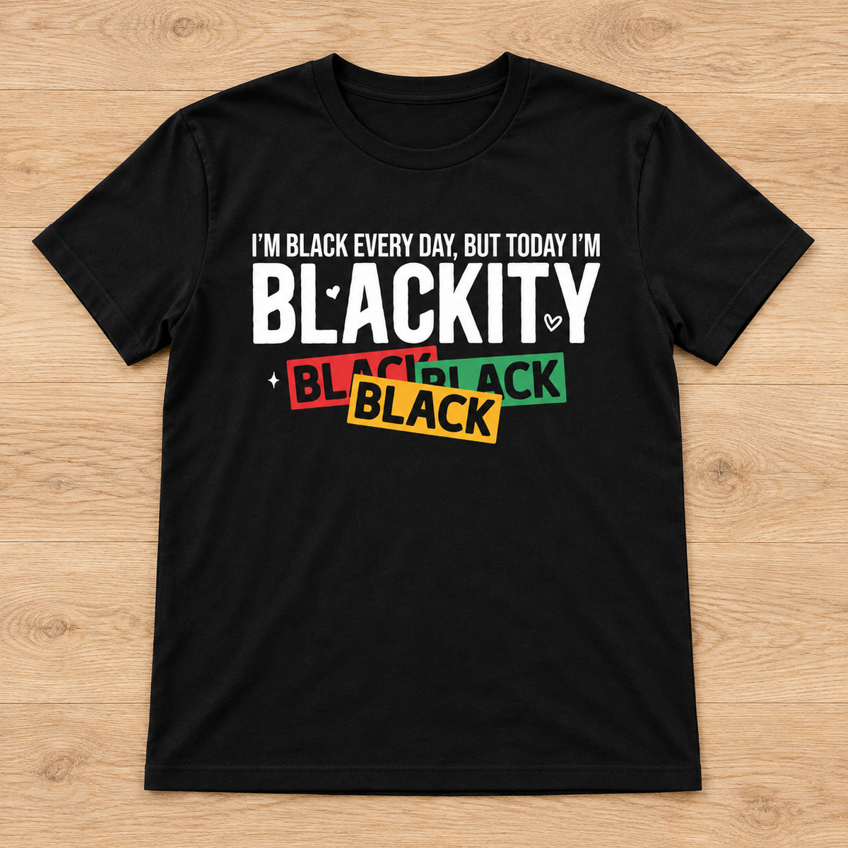 Black Blackity Black Juneteenth Tee laid flat on light wood