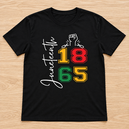 Black Juneteenth 1865 Raised Fist Tee laid flat on light wood